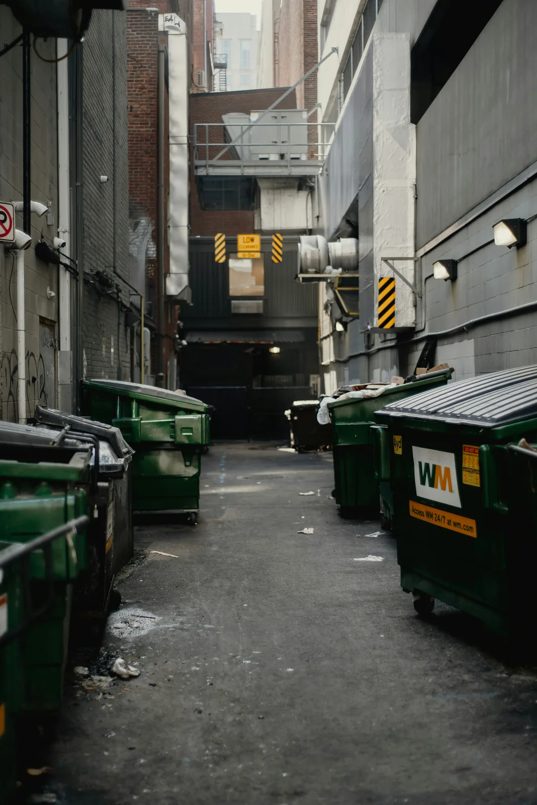 An alley lined with front-load dumpsters
