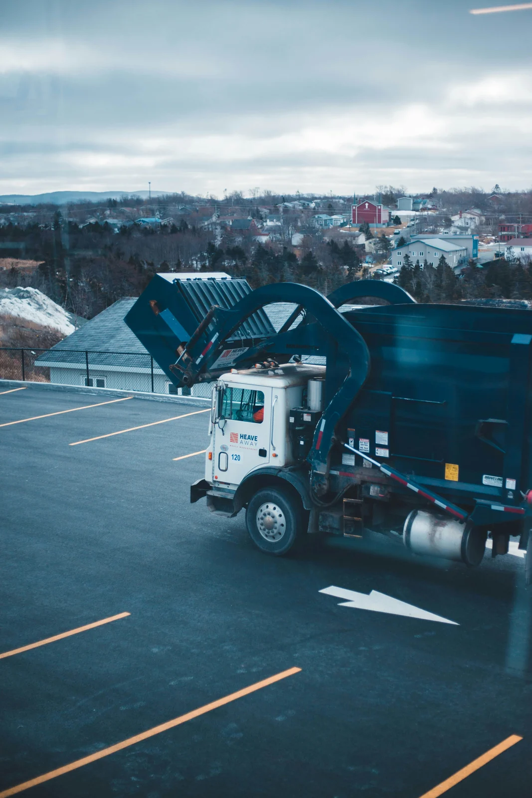 A front-load truck lifting a container overhead